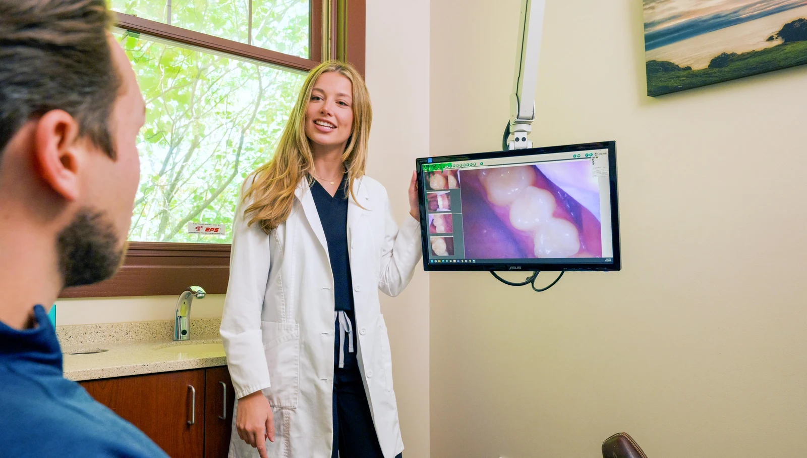 Dr. Austin reviewing intraoral camera images with a patient