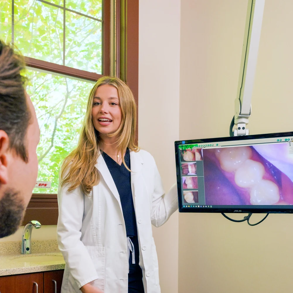 Dr. Austin reviewing intraoral camera images with a patient
