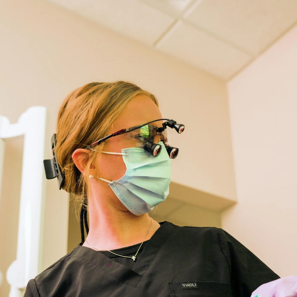 A hygienist carefully examining a patient's teeth