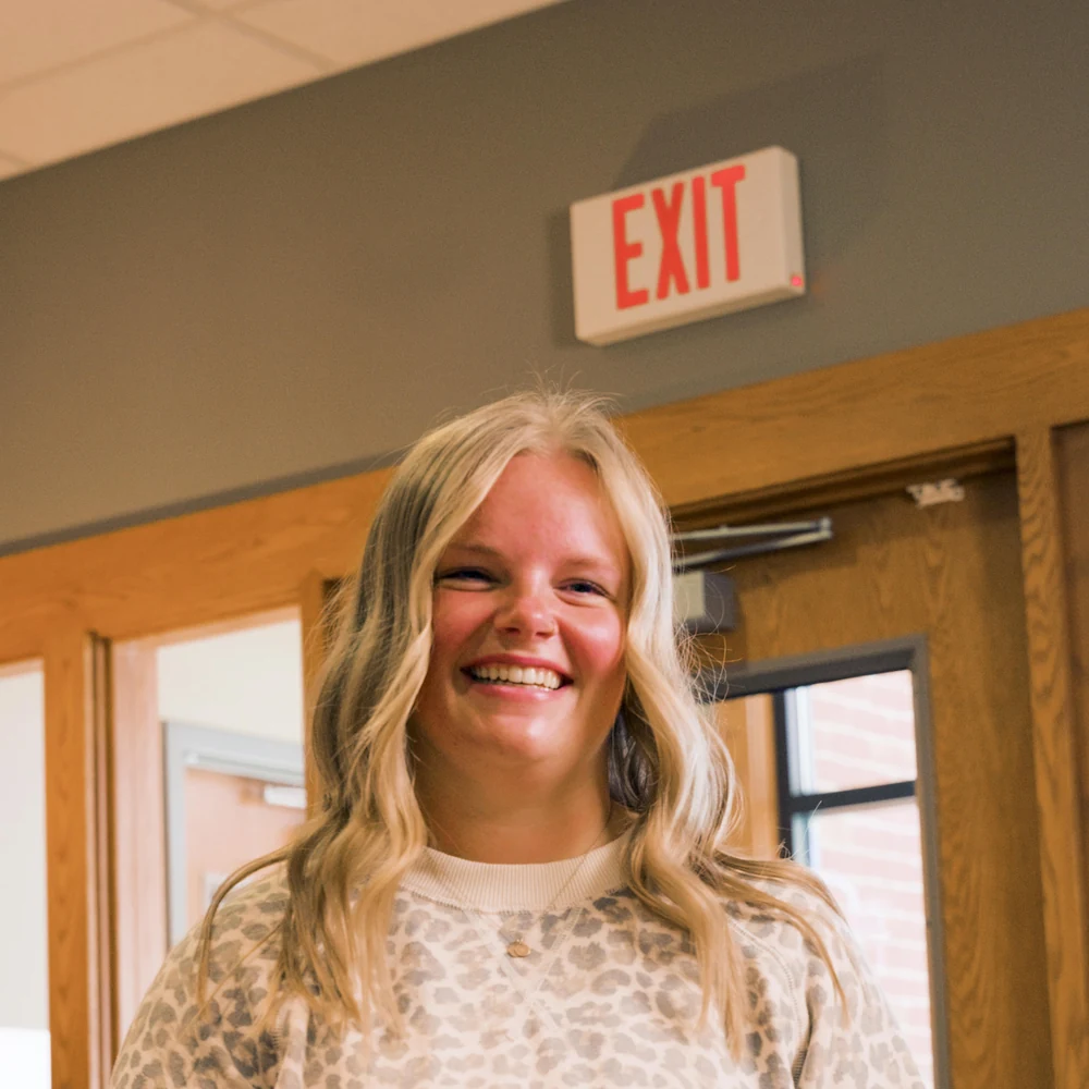A team member warmly welcoming a patient at the front desk