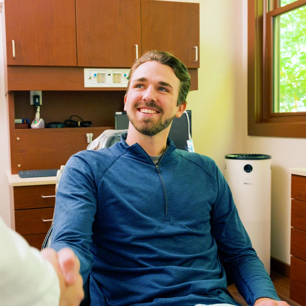 A smiling patient in the dental chair