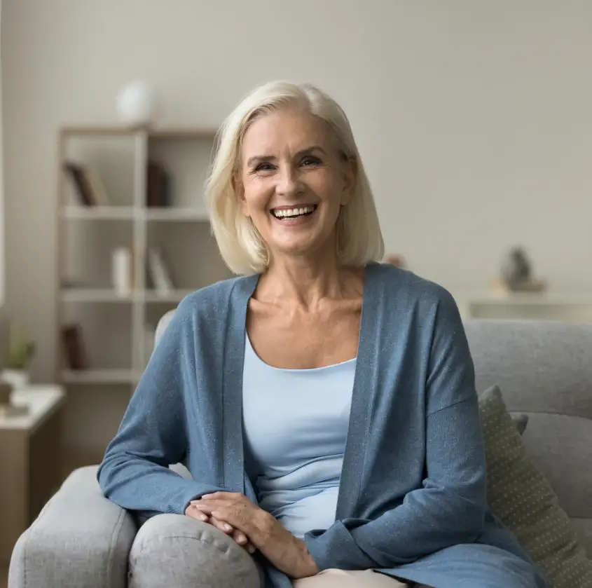 A woman smiling at home, relaxed and confident in her smile