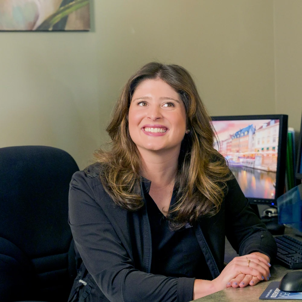 A team member smiling at the front desk